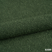 Dunkelgrüner Bouclé-Bezug der Premium-Massageliege ELEMENT, hochwertige Polsterung.