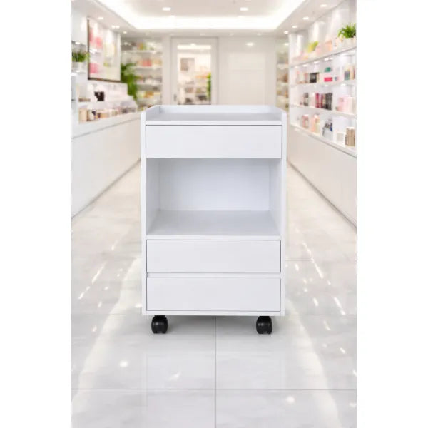White wooden cosmetic cart with drawers and open shelf on wheels, Tocky WKT901 in a bright salon.