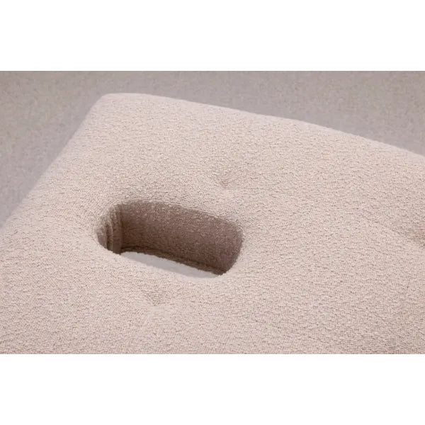 Beiger Bezug einer Massageliege mit Gesichtsöffnung, texturierter Bouclé-Stoff.