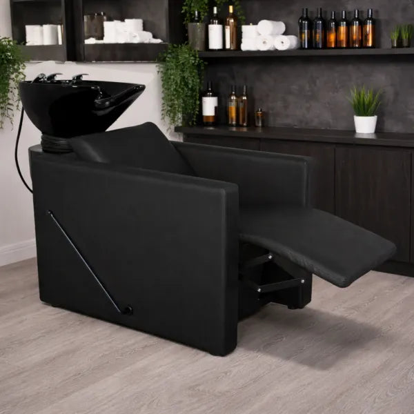 Friseurwaschbecken PEEK+ – Rückwärtswaschbecken mit manueller Fußstütze, schwarzer Friseurstuhl im Salon.