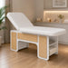 INDUS spa cosmetic bed with hydraulic backrest, white upholstery, oak panels and storage shelves.