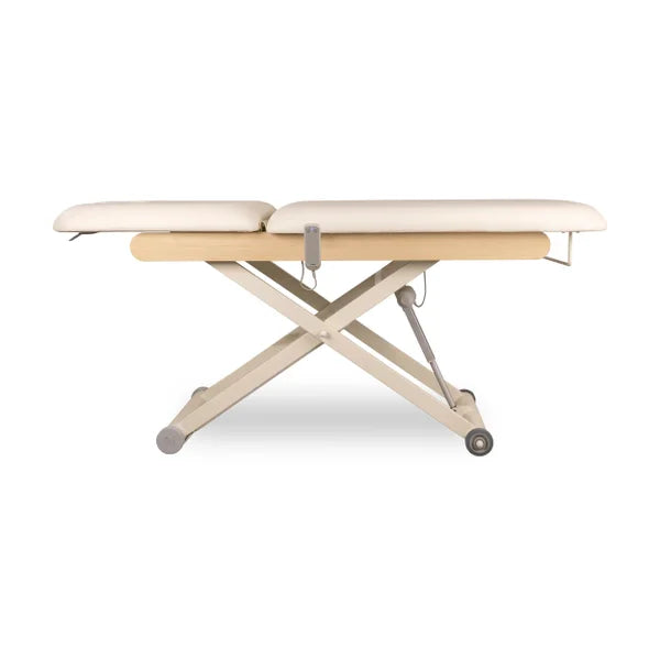 DRACO electric cosmetic bed, professional massage & spa table with 1 motor, beige upholstery on a wheeled X-frame.