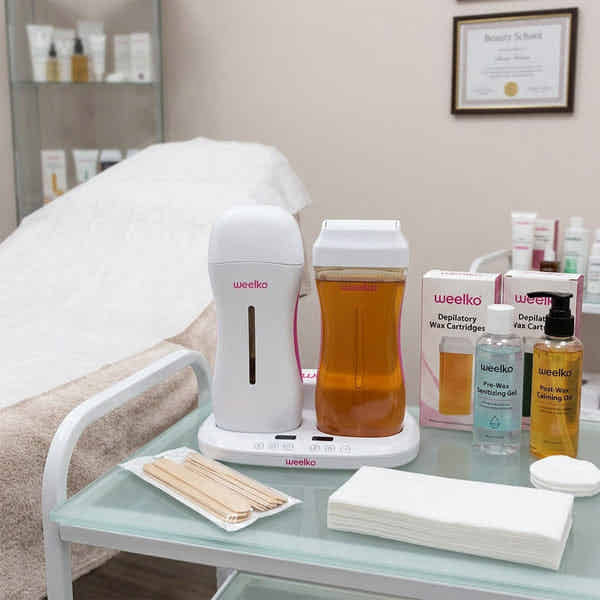 DUOWAX Dual Wax Heater for two roll-on cartridges with LCD and temperature control on a spa treatment cart.