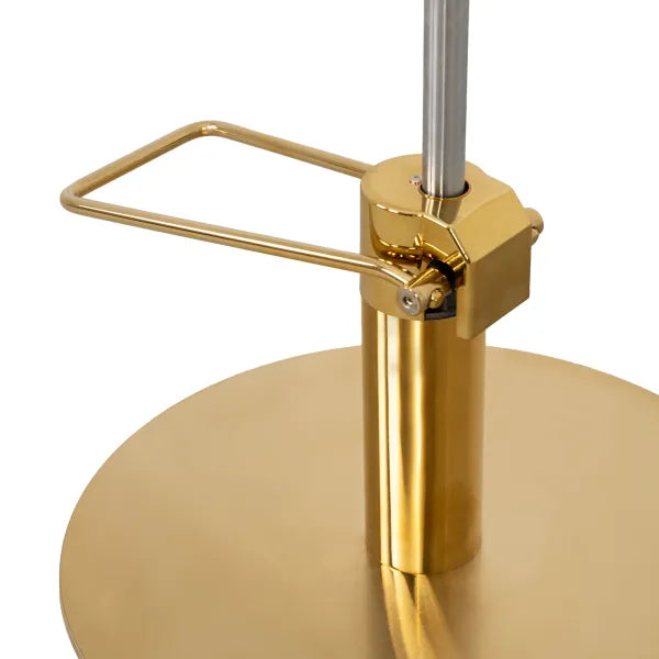Goldfarbener Hydraulikzylinder und Kreisfuß eines Friseurstuhls mit praktisches Abstellgestell für moderne Salons.