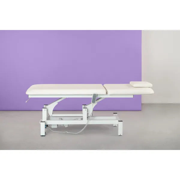 Electric massage table with one motor, height-adjustable treatment bed against a purple backdrop