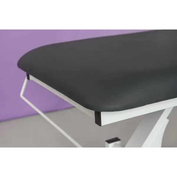 Electric massage table with one motor, height-adjustable, black padded surface and white frame.