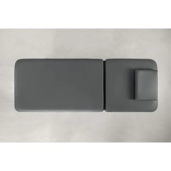 Top-down view of a gray two-section electric massage bed with a headrest cushion.
